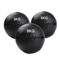 Three black wall balls with weight markings on a white background