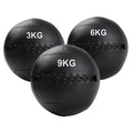 Three black wall balls with weight markings on a white background