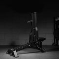 Black weight bench in a gym setting with a dark background