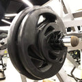 Close-up of a weight plate on a barbell in a gym setting