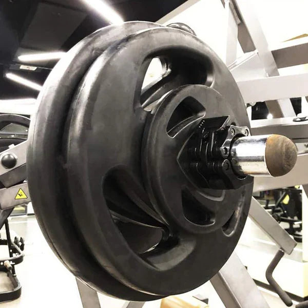 Close-up of a weight plate on a barbell in a gym setting