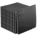 Stack of black interlocking foam mats on a white background