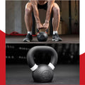 Person lifting a kettlebell with a close-up of the kettlebell below.
