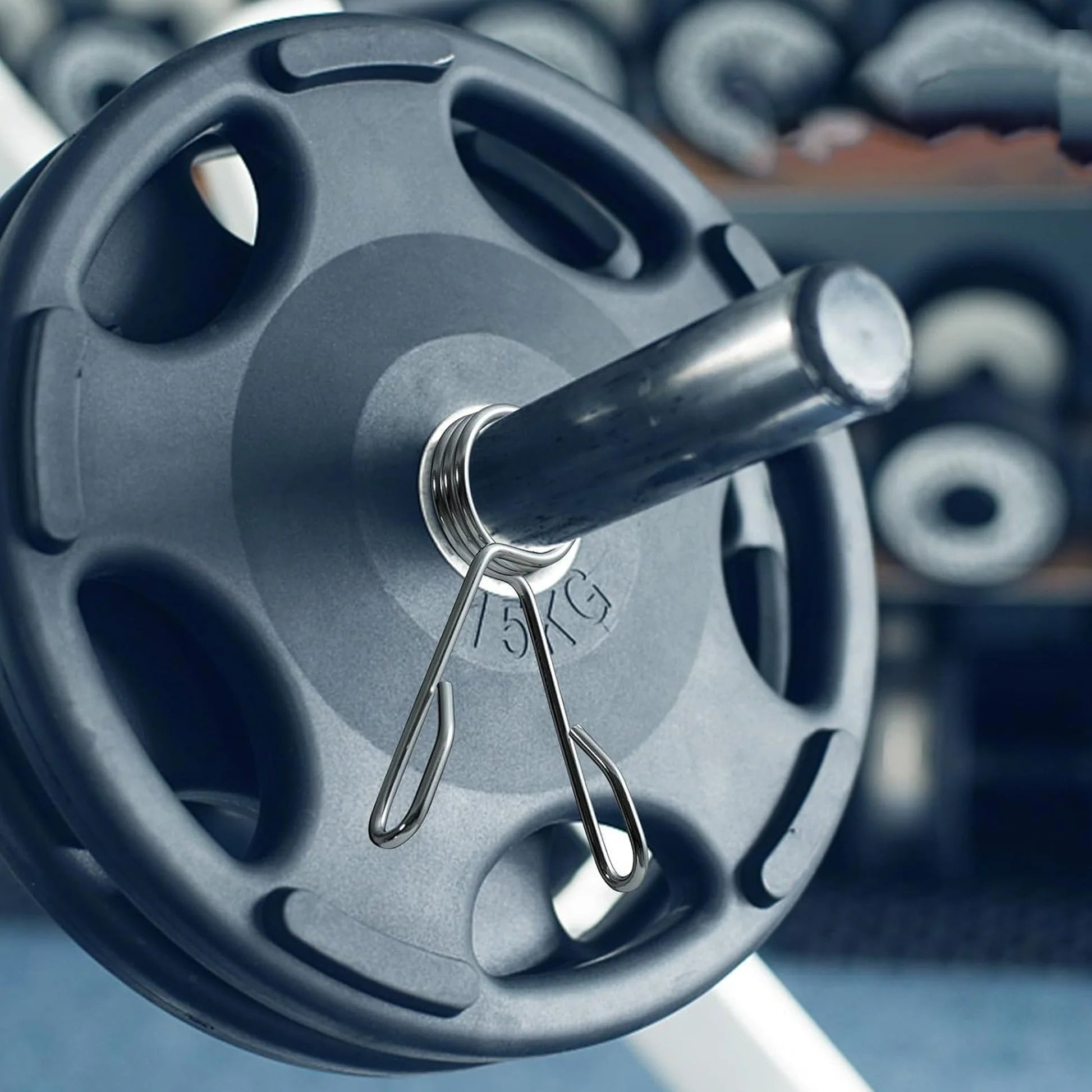 Woman exercising with blue dumbbells on a step platform in a gym.