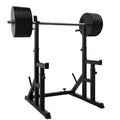 Black weightlifting power rack with barbell on a white background