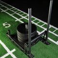 Weightlifting barbell with weight plates on a sports field