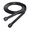 Black jump rope coiled on a white background