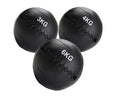 Three black weighted medicine balls with weight markings on a white background